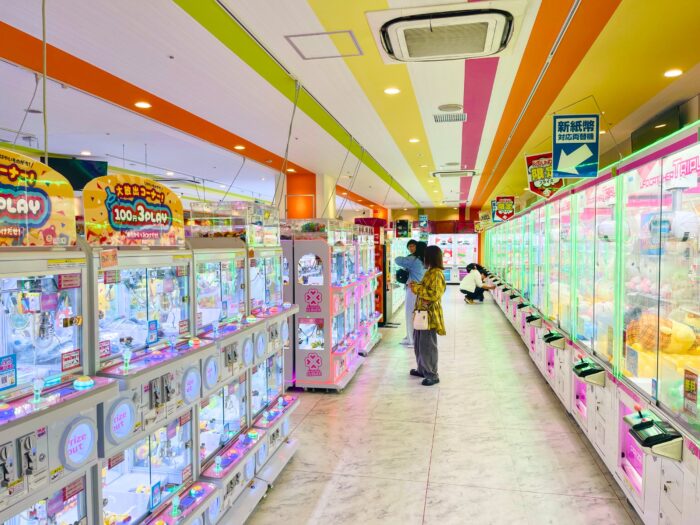 Binnenkant van een winkel vol met grijparm machines. Zeer helder verlicht met zuurstokkleuren